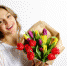 Happy smiling girl with flowers in their hands, the Concept of International Women's Day - Газета Дело Октября